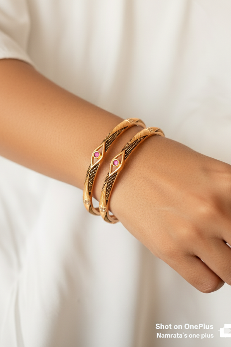 Elegant Golden Bangles with Black Detailing & Pink Stone Centerpiece