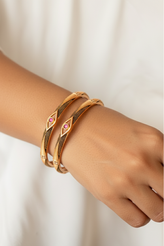 Elegant Golden Bangles with Black Detailing & Pink Stone Centerpiece