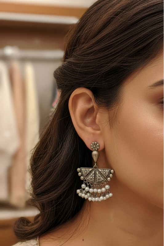 Close-up of a woman wearing a decorative earring with a blurred background