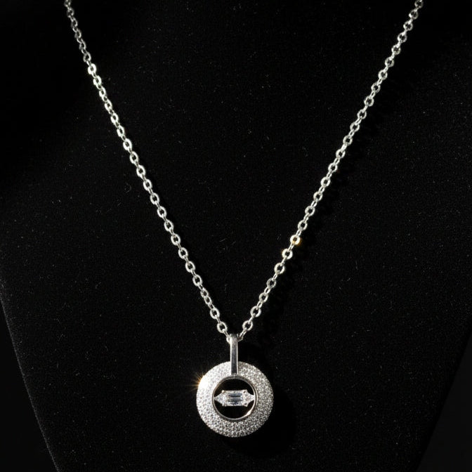 Silver necklace with a pendant on a black background